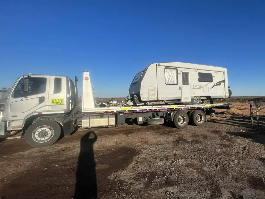 AMAX tilt tray truck carrying a Lotus caravan near Whyalla